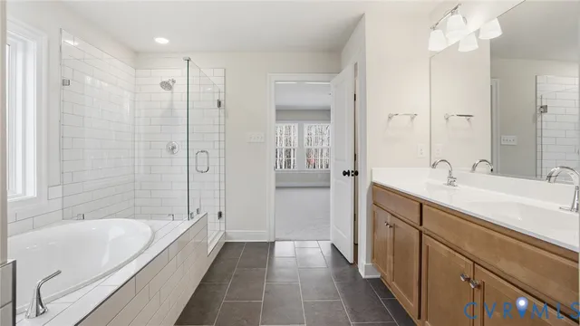 a spacious bathroom with a bathtub shower sink and mirror