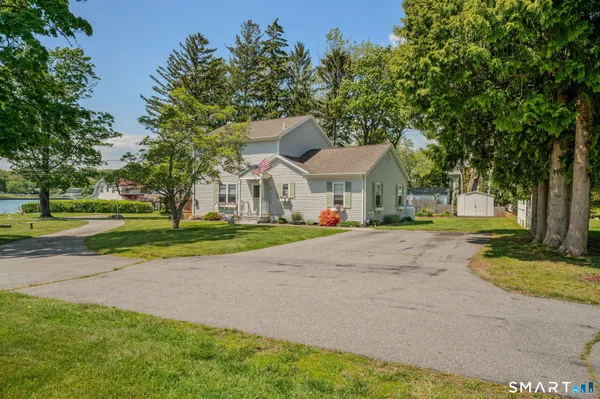 a view of house with yard and tree s
