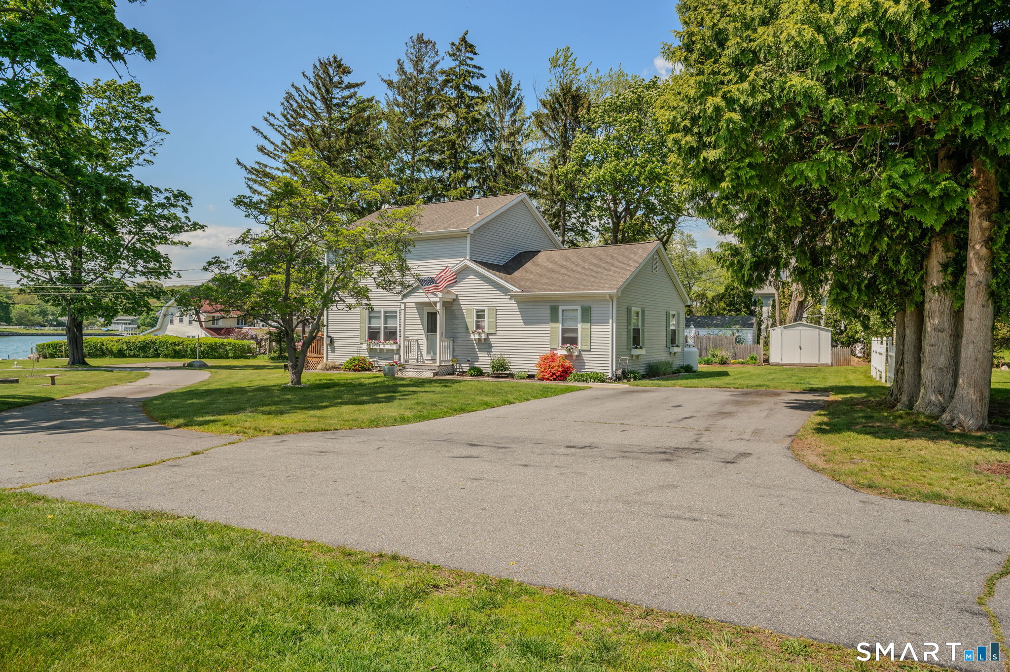 a view of house with yard and tree s