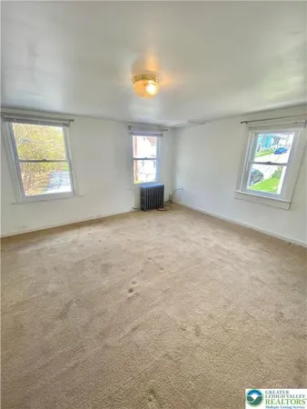 an empty room with windows and entrance