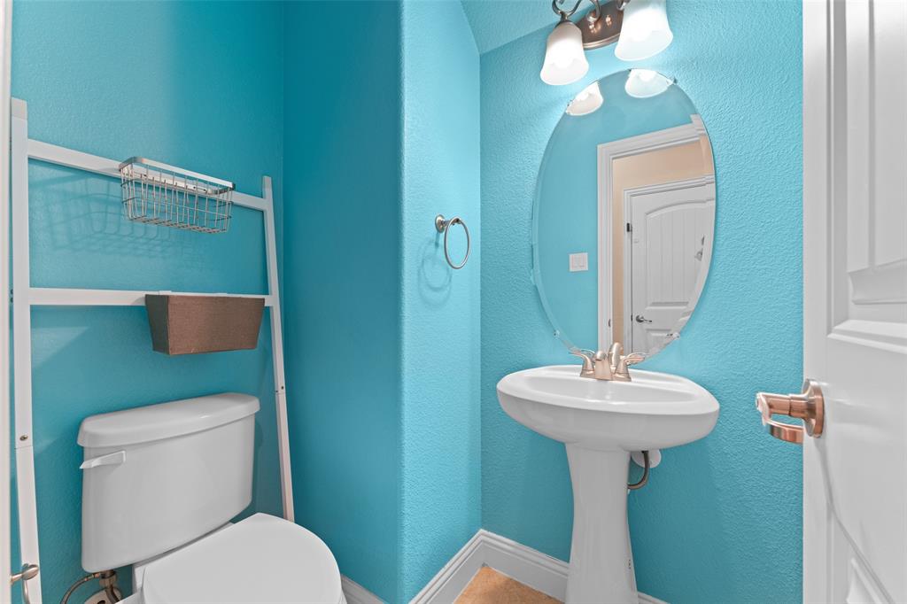 600 Fishback Circle Plano, TX 75074 - Photo 31 of 38 a bathroom with a toilet sink and mirror