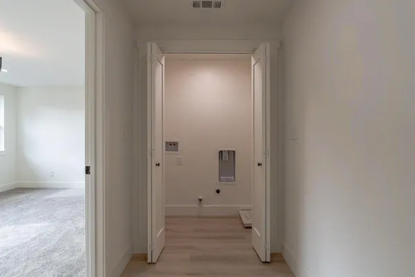 an empty room with windows and entrance