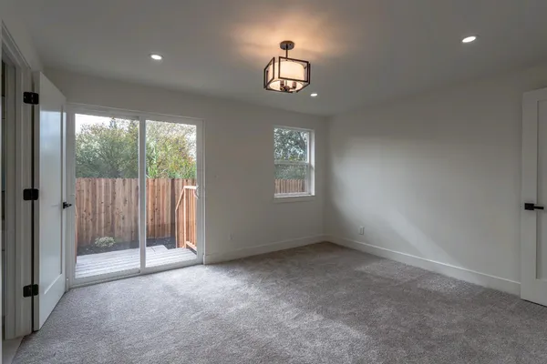 an empty room with windows and closet