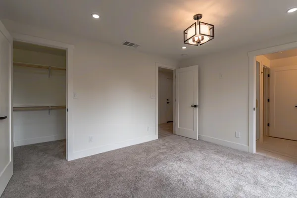 an empty room with windows and closet