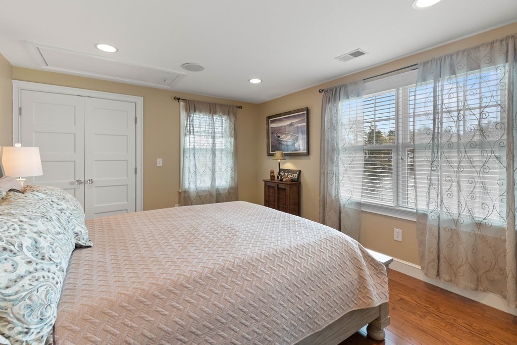 4 Birchmeadow Road Amesbury, MA 01913 - Photo 29 of 42 a bedroom with a large bed and wooden floor