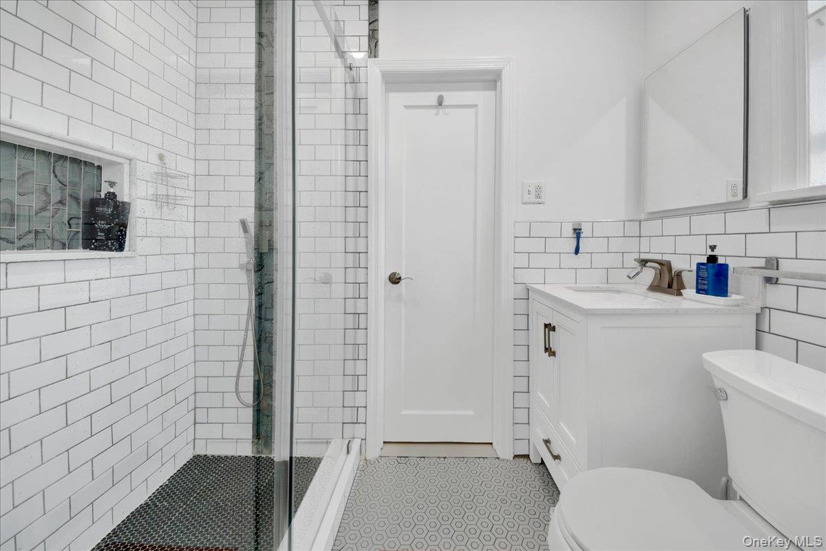 4784 Boston Post Road, Unit B43 Pelham, NY 10803 - Photo 13 of 22 a bathroom with a sink toilet and shower
