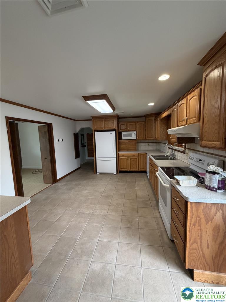 5391 Chapmans Road, Unit 2 Orefield, PA 18069 - Photo 2 of 22 A well-equipped kitchen features tile flooring and ample cabinetry for all your culinary needs.