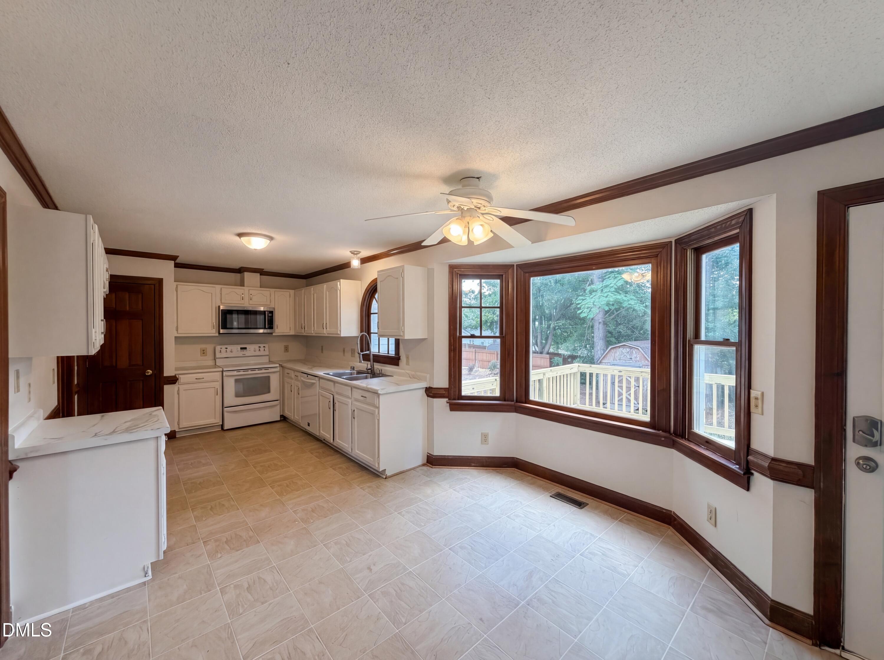 3921 Iron Horse Road Raleigh, NC 27616 - Photo 5 of 20 a large white kitchen with a large window