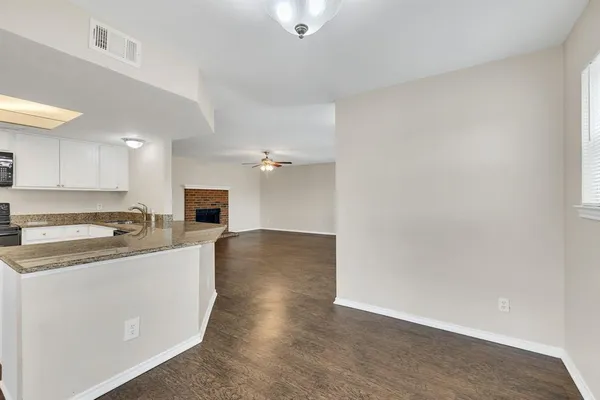 a kitchen with stainless steel appliances granite countertop a stove a sink and a microwave