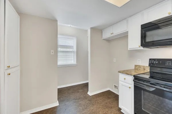 a kitchen with stainless steel appliances granite countertop a sink and a stove