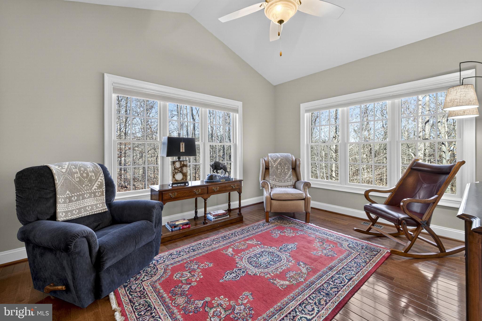8485 Rogues Road Warrenton, VA 20187 - Photo 11 of 121 a living room with furniture a rug and a chandelier