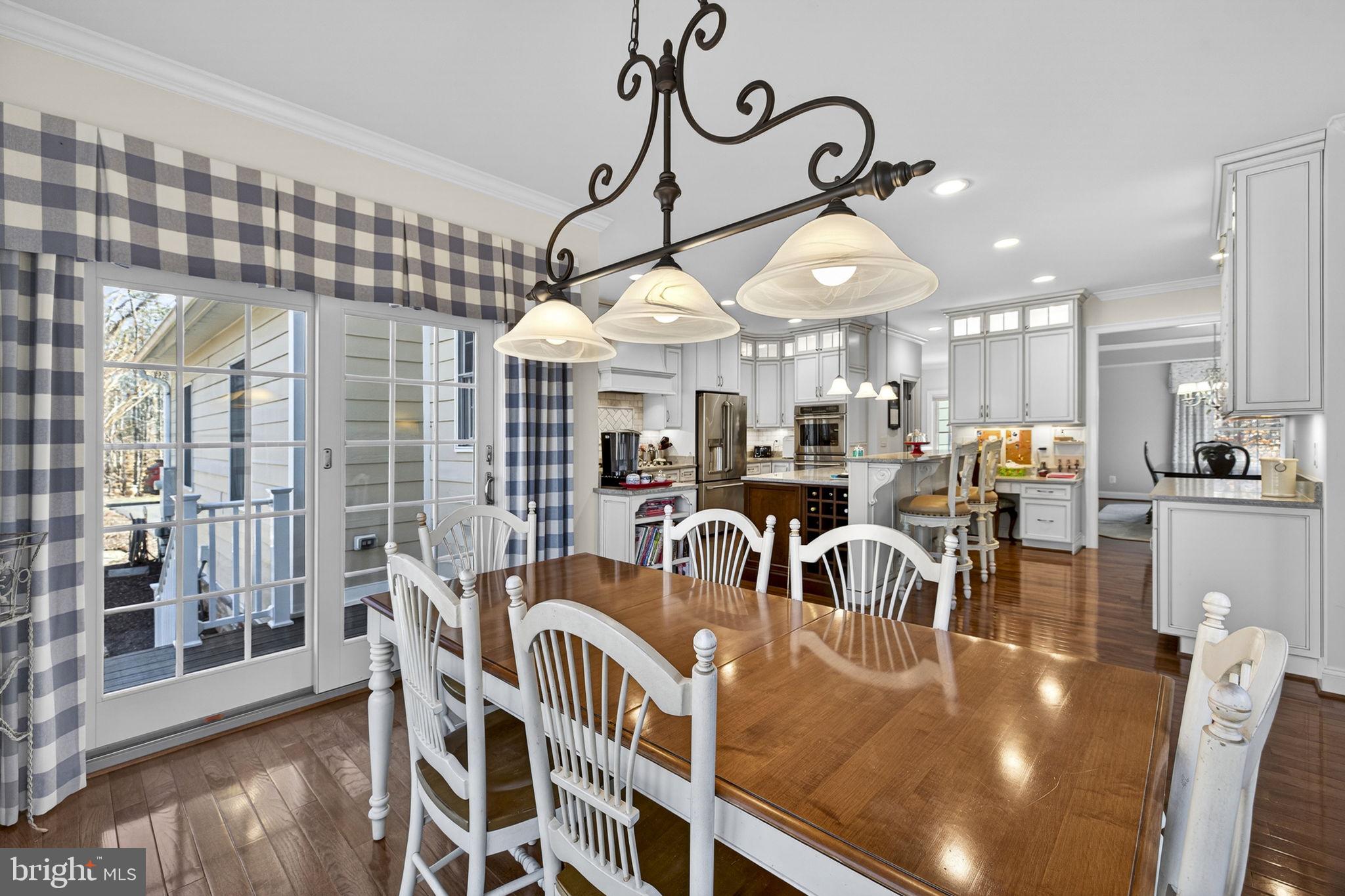 8485 Rogues Road Warrenton, VA 20187 - Photo 19 of 121 a view of a dining room with furniture chandelier and wooden floor