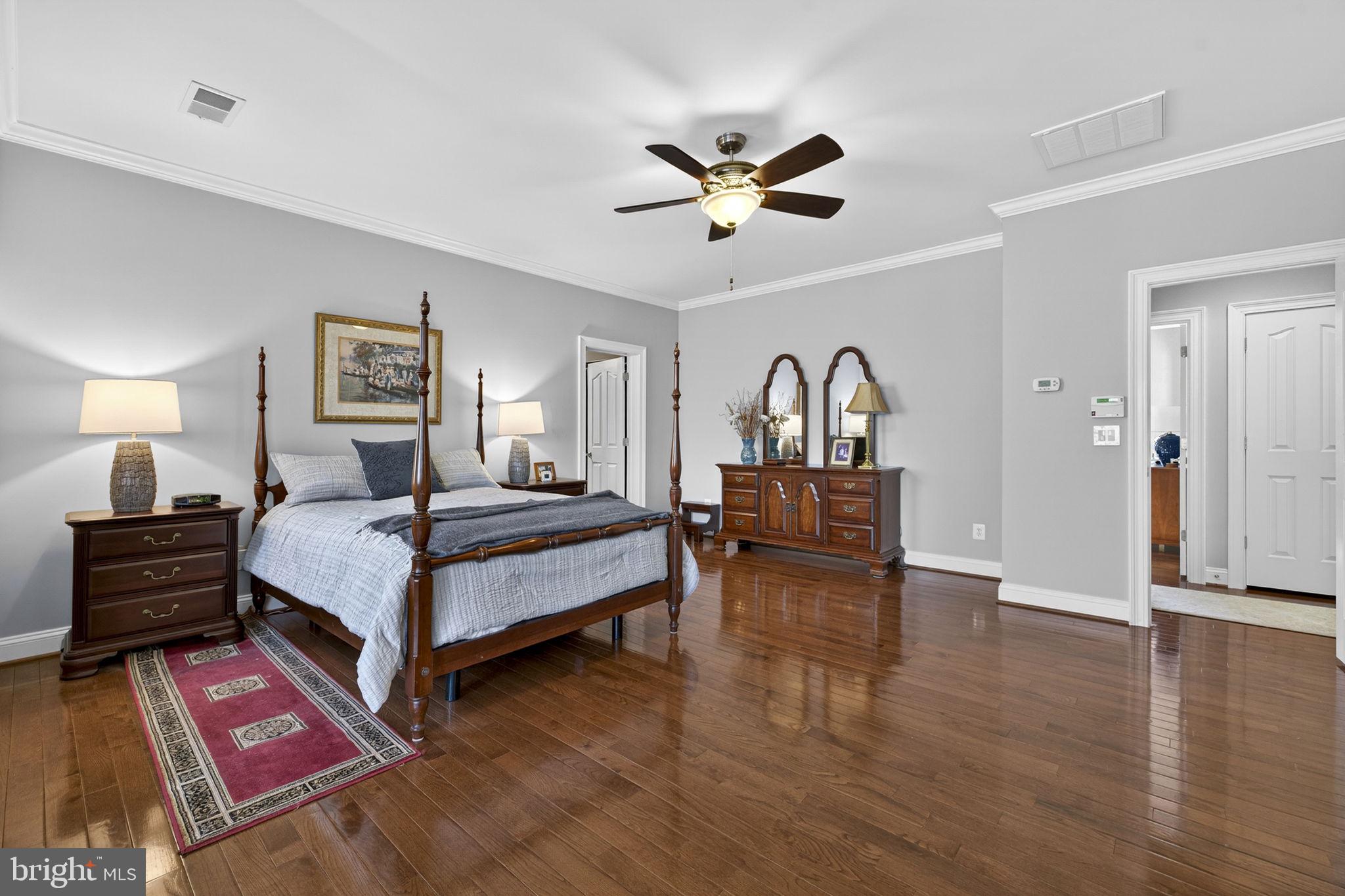 8485 Rogues Road Warrenton, VA 20187 - Photo 29 of 121 a bedroom with a bed and dresser with wooden floor