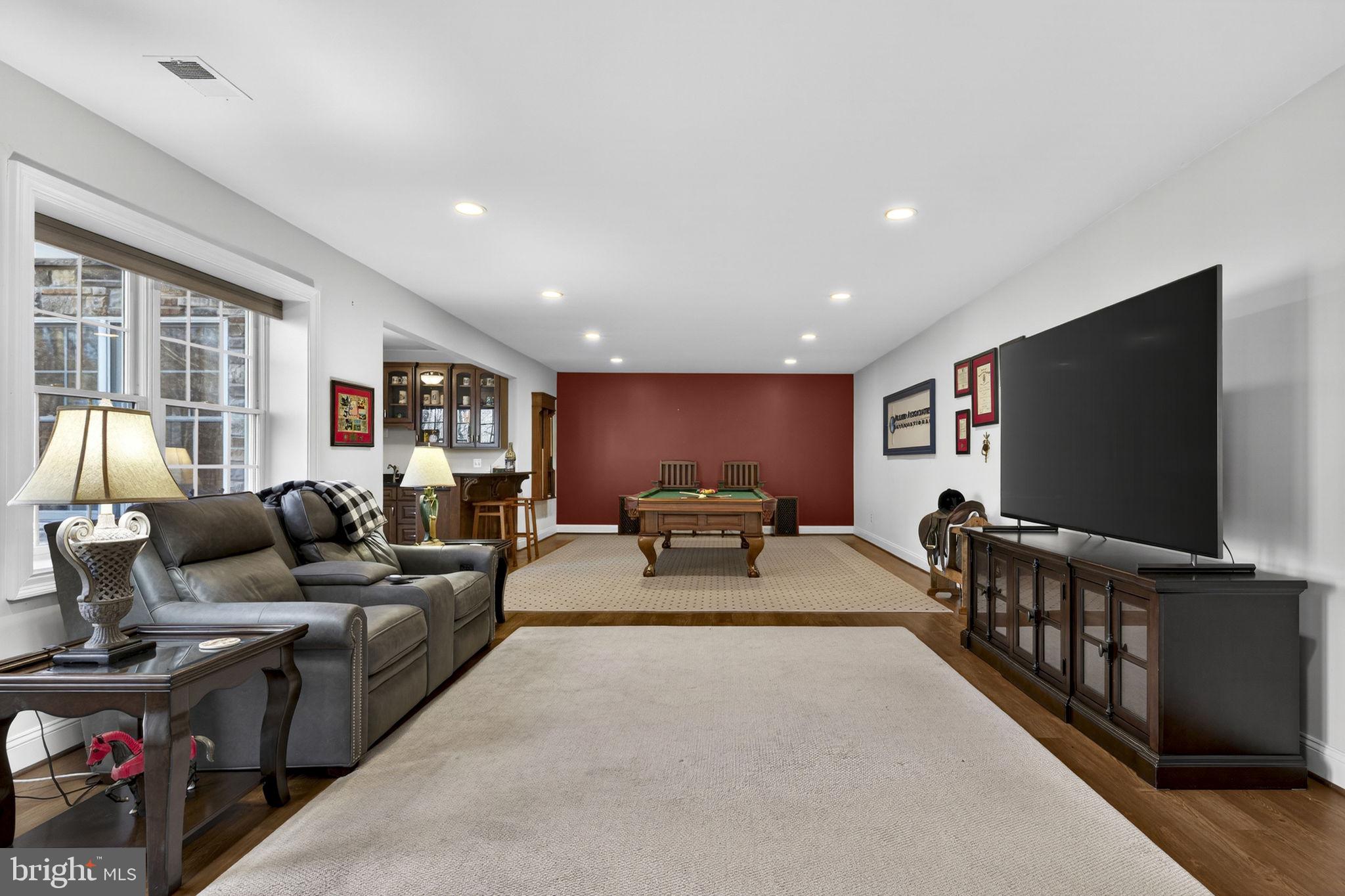 8485 Rogues Road Warrenton, VA 20187 - Photo 45 of 121 a living room with furniture and a flat screen tv