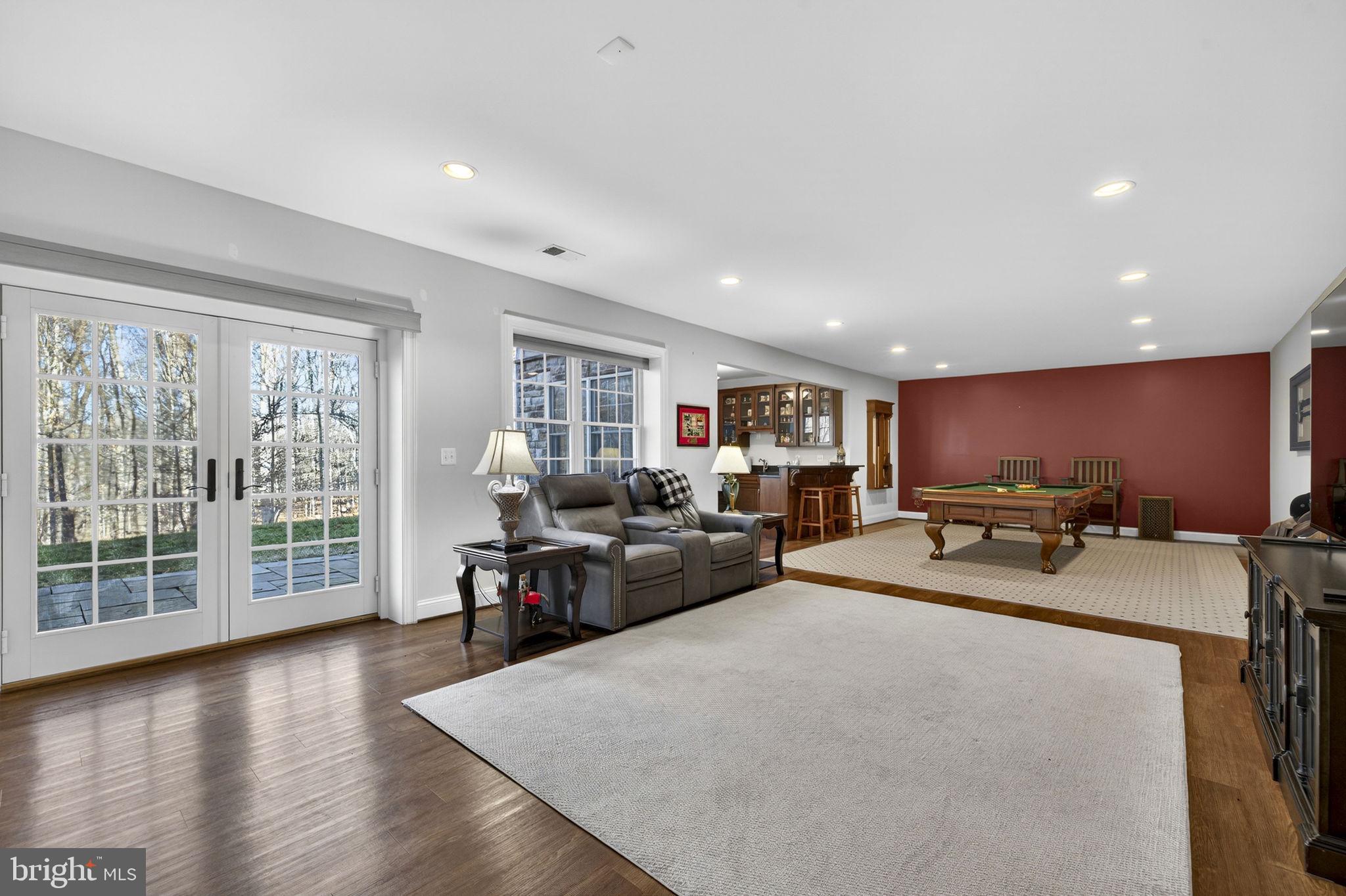 8485 Rogues Road Warrenton, VA 20187 - Photo 46 of 121 a living room with furniture and a wooden floor