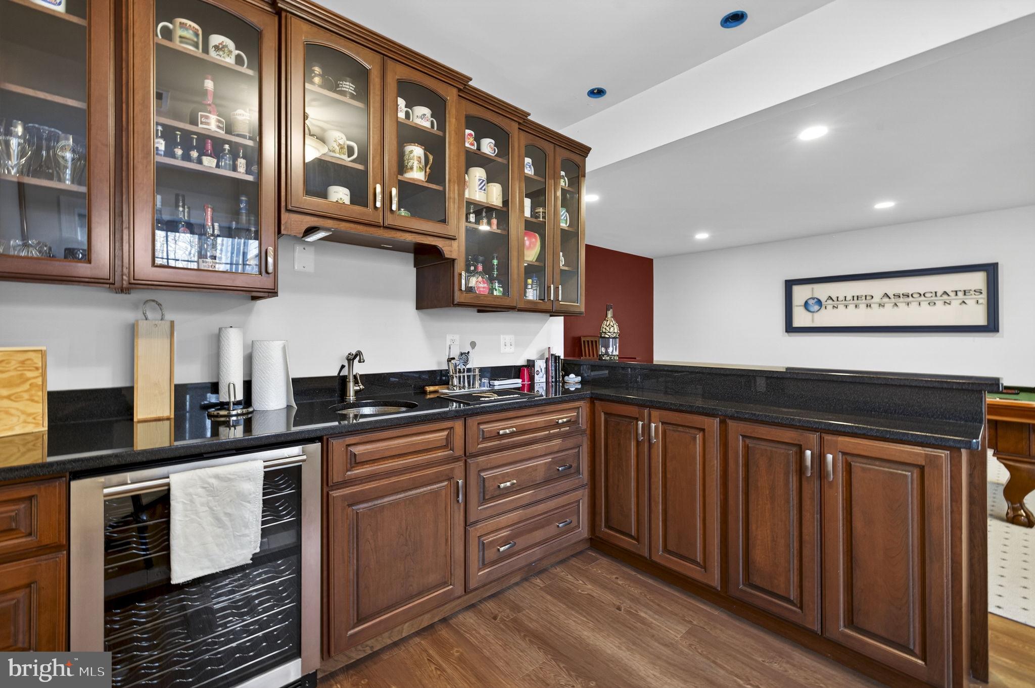 8485 Rogues Road Warrenton, VA 20187 - Photo 47 of 121 a kitchen with stainless steel appliances granite countertop a stove a sink and a granite counter tops with wooden floors
