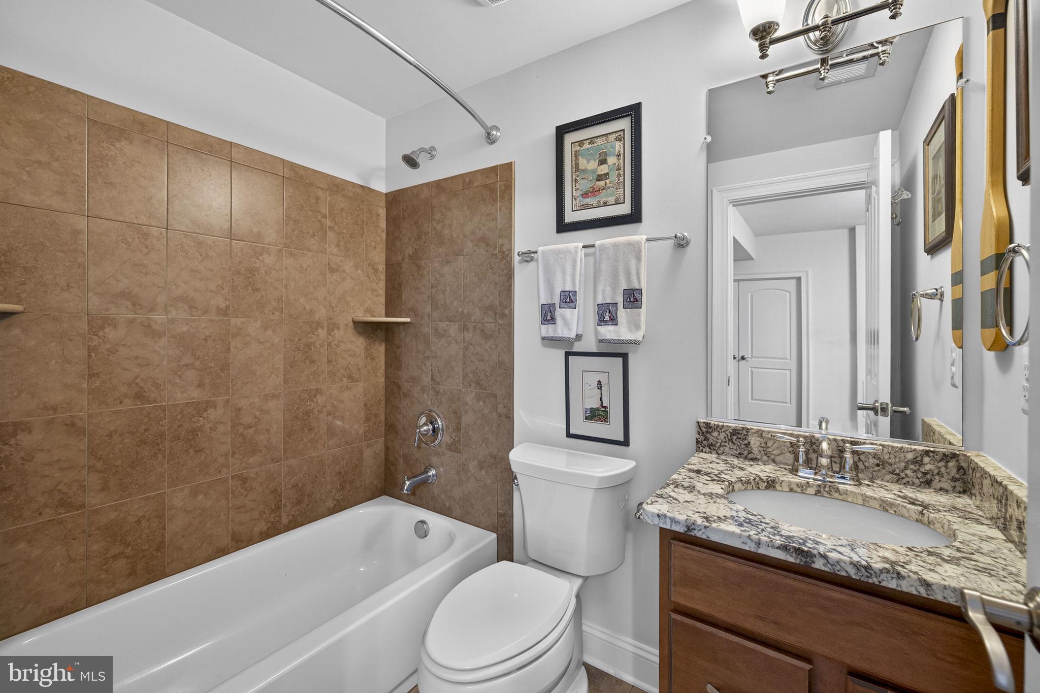 8485 Rogues Road Warrenton, VA 20187 - Photo 49 of 121 a bathroom with a granite countertop sink toilet and shower