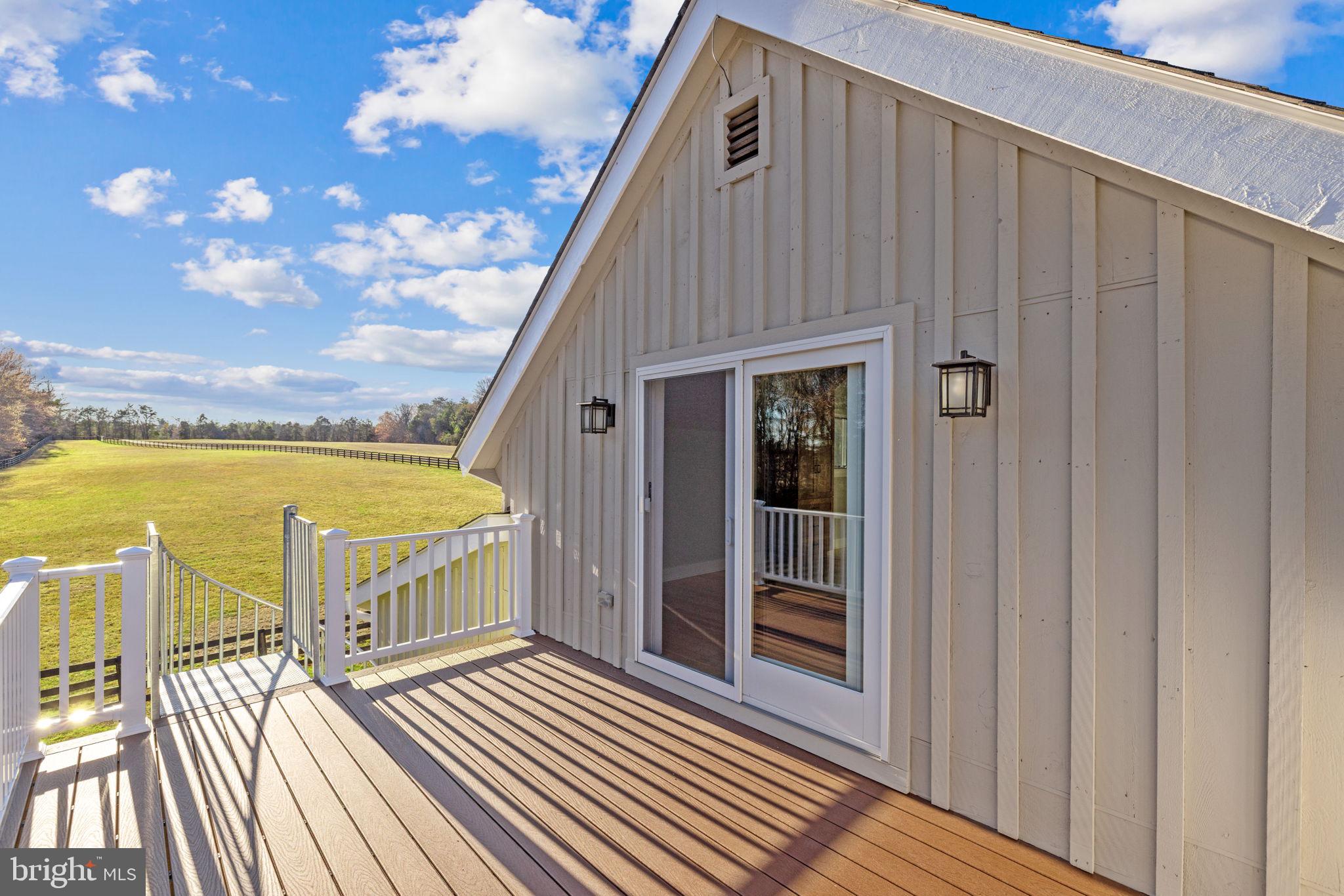8485 Rogues Road Warrenton, VA 20187 - Photo 77 of 121 a view of a balcony with wooden floor and city view