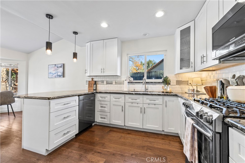 28046 Millar Street Highland, CA 92346 - Photo 13 of 39 a kitchen with stainless steel appliances granite countertop a stove and a sink