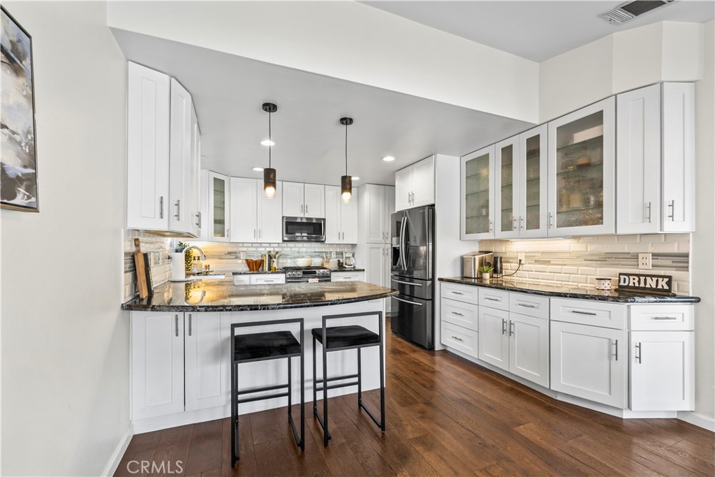 28046 Millar Street Highland, CA 92346 - Photo 14 of 39 a kitchen with white cabinets and appliances