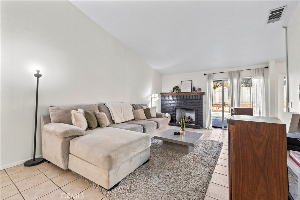 28046 Millar Street Highland, CA 92346 - Photo 15 of 39 a living room with furniture and a fireplace