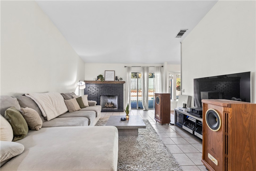 28046 Millar Street Highland, CA 92346 - Photo 17 of 39 a living room with furniture and a flat screen tv