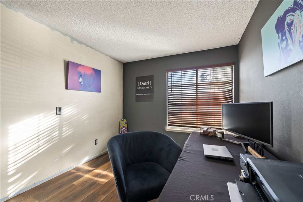 28046 Millar Street Highland, CA 92346 - Photo 23 of 39 a bedroom with furniture and a flat screen tv