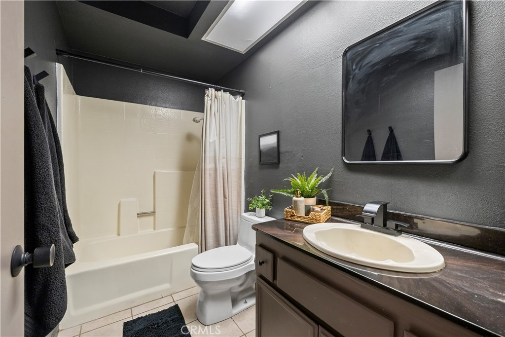 28046 Millar Street Highland, CA 92346 - Photo 26 of 39 a bathroom with a granite countertop sink toilet and shower