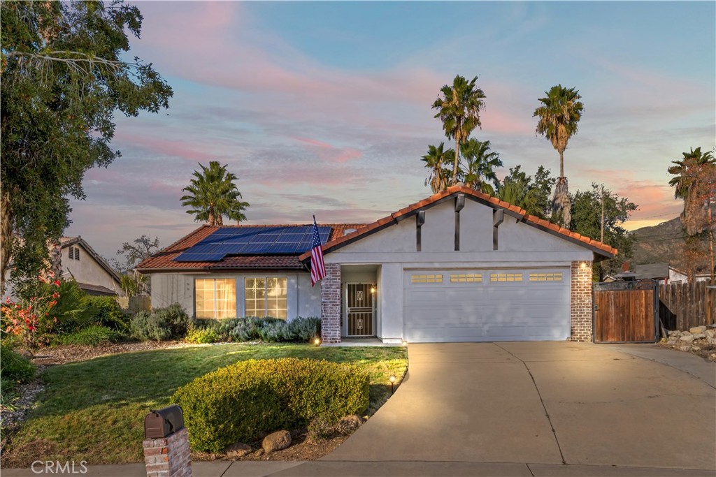 28046 Millar Street Highland, CA 92346 - Photo 3 of 39 a front view of a house with a yard and garage