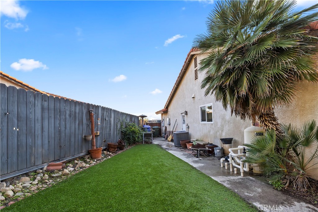 28046 Millar Street Highland, CA 92346 - Photo 35 of 39 a view of a backyard with potted plants and a palm tree