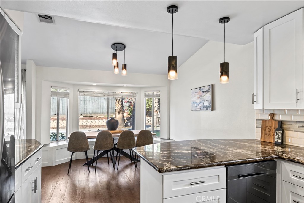 28046 Millar Street Highland, CA 92346 - Photo 7 of 39 a view of a dining room and livingroom with furniture wooden floor a chandelier