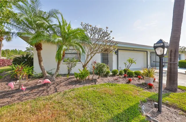 a view of an house with a yard and garage