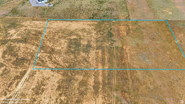 16013 North 6125th Street West Riverside, UT 84334 - Photo 6 of 10 Expansive undeveloped land parcel featuring natural grasses and distant residential structures