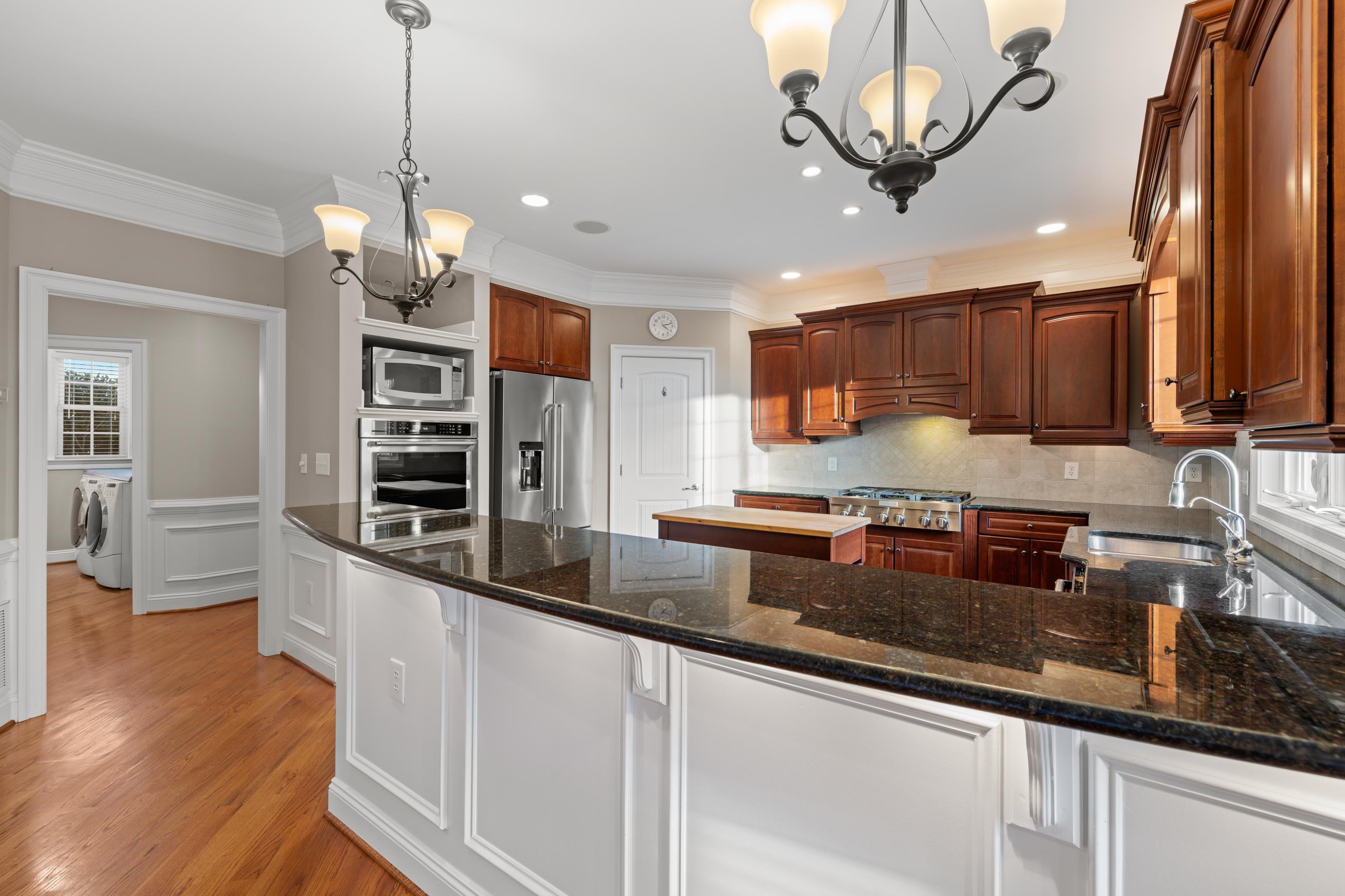 3485 Barterbrook Road Staunton, VA 24401 - Photo 14 of 71 a kitchen with stainless steel appliances granite countertop a sink a stove and a wooden floors