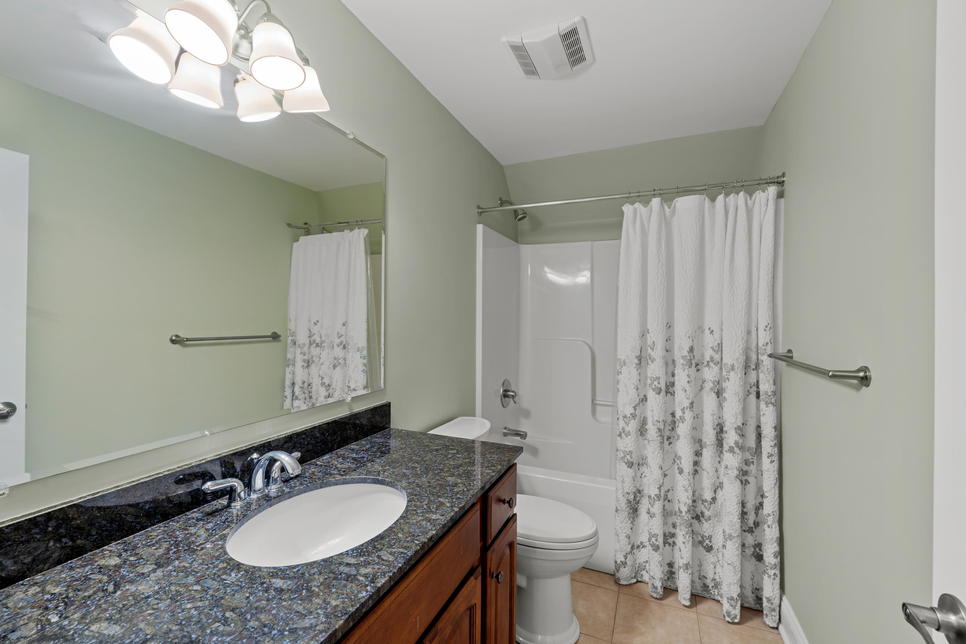 3485 Barterbrook Road Staunton, VA 24401 - Photo 44 of 71 a bathroom with a granite countertop sink toilet a mirror a vanity and shower