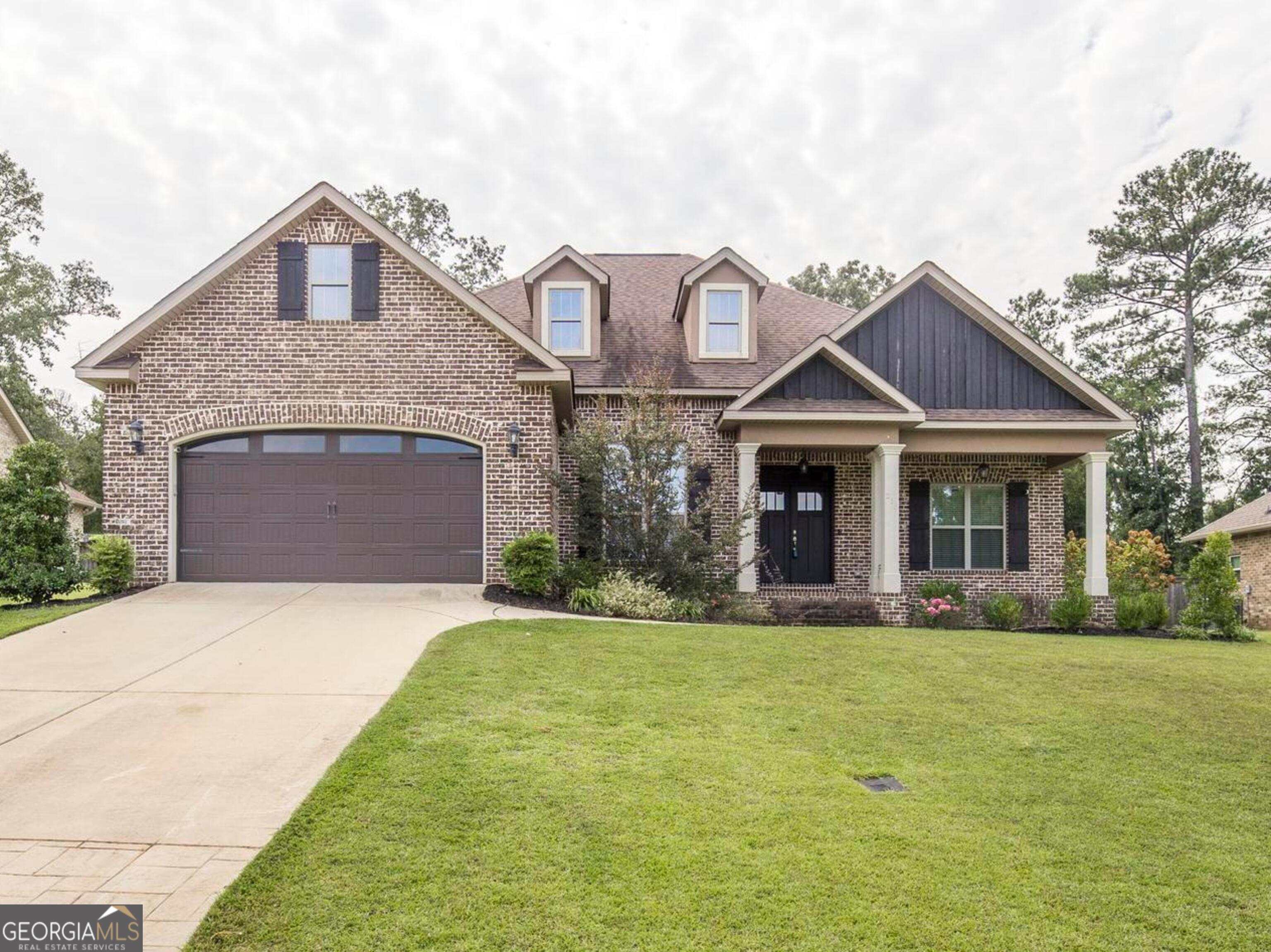 a front view of a house with a yard and garage
