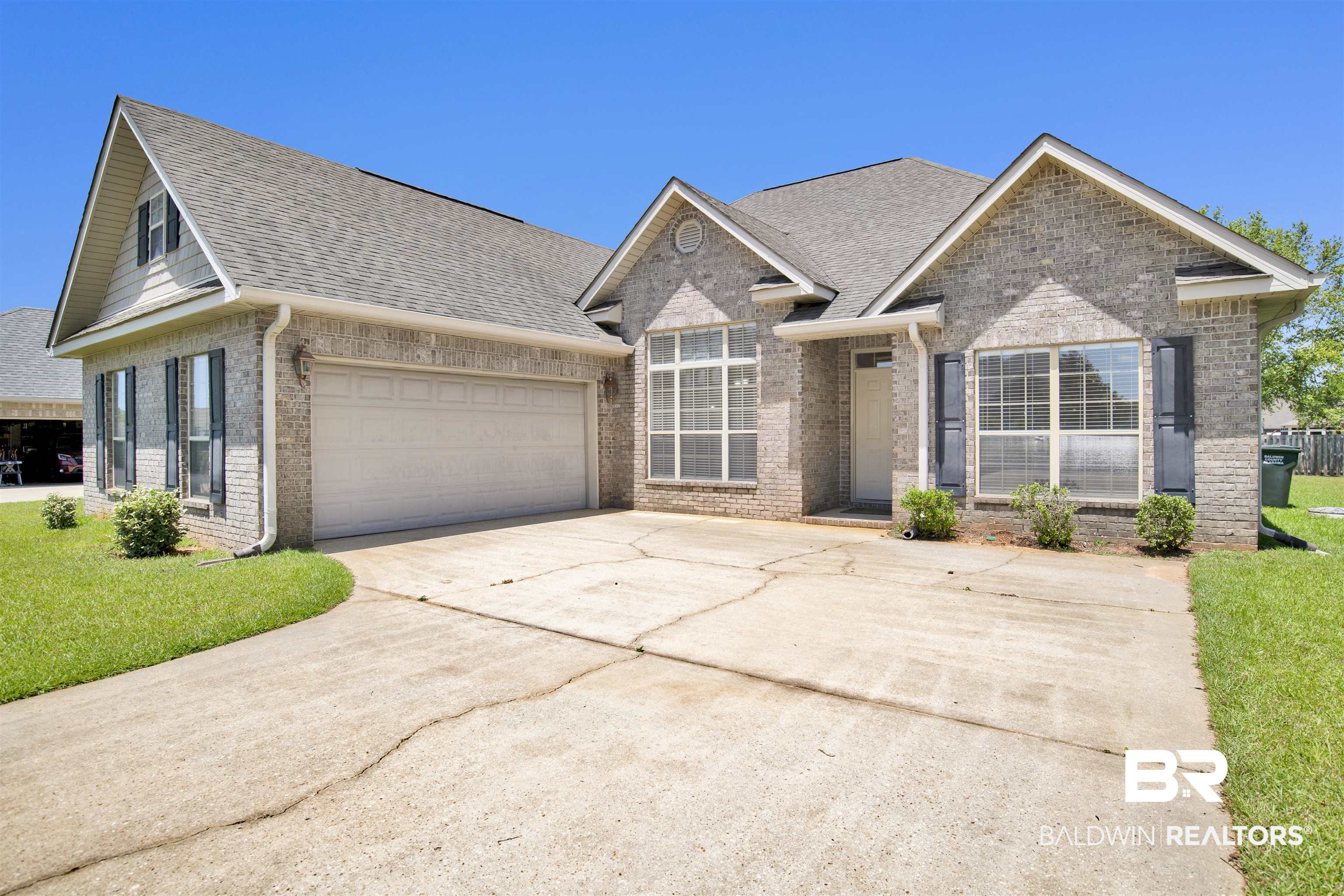 10910 Roanoke Loop Daphne, AL 36526 - Photo 4 of 33 Single story home with driveway, roof with shingles, brick siding, and a front yard