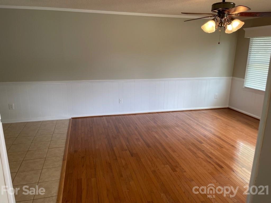 129 Loray Farm Road Dallas, NC 28034 - Photo 13 of 28 a view of an empty room with wooden floor and fan