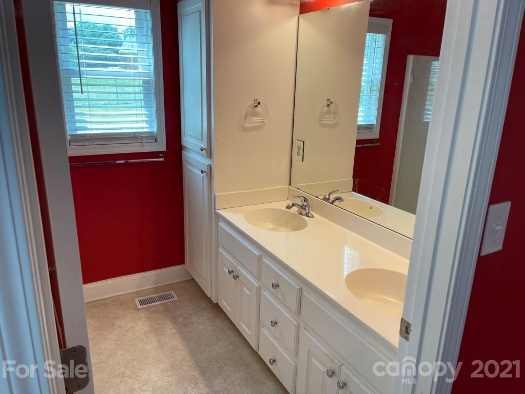129 Loray Farm Road Dallas, NC 28034 - Photo 17 of 28 a bathroom with a double vanity sink and a mirror