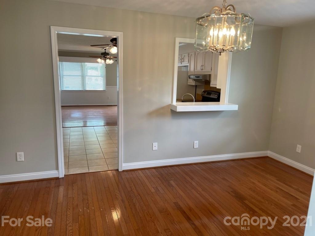 129 Loray Farm Road Dallas, NC 28034 - Photo 20 of 28 a view of an empty room with wooden floor and chandelier