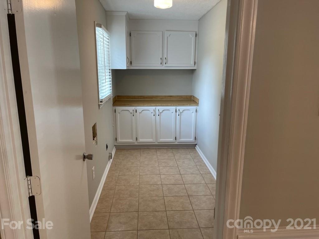 129 Loray Farm Road Dallas, NC 28034 - Photo 22 of 28 a kitchen with white cabinets and a sink
