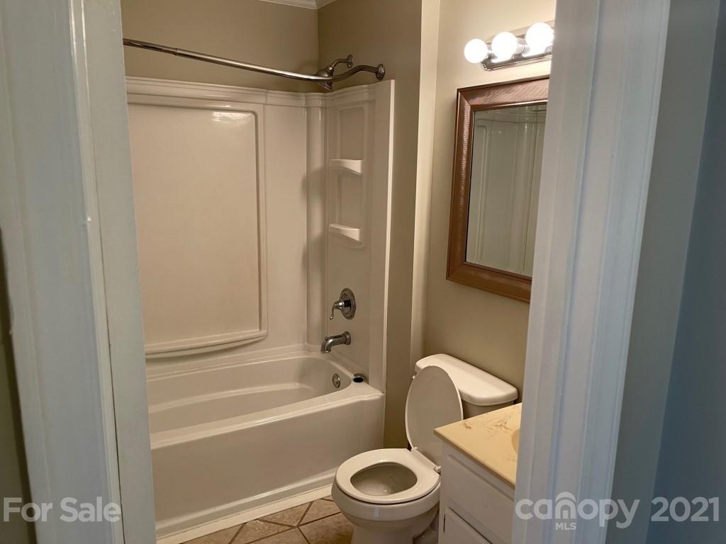 129 Loray Farm Road Dallas, NC 28034 - Photo 28 of 28 a bathroom with a toilet and a bathtub