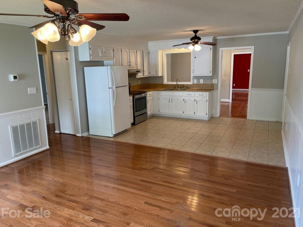 129 Loray Farm Road Dallas, NC 28034 - Photo 10 of 28 a kitchen with stainless steel appliances granite countertop a refrigerator a stove top oven a sink and dishwasher