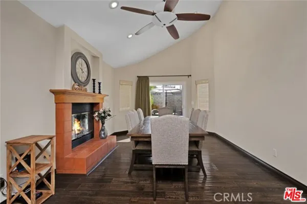 a view of a dining room with furniture wooden floor carpet and a chandelier