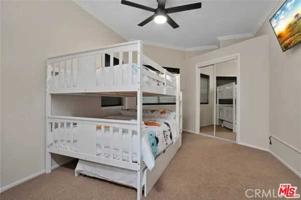 a bedroom with furniture and a tv