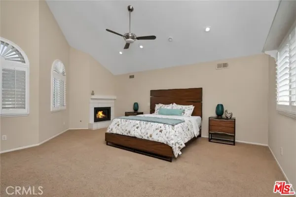 a spacious bedroom with a bed and a chandelier