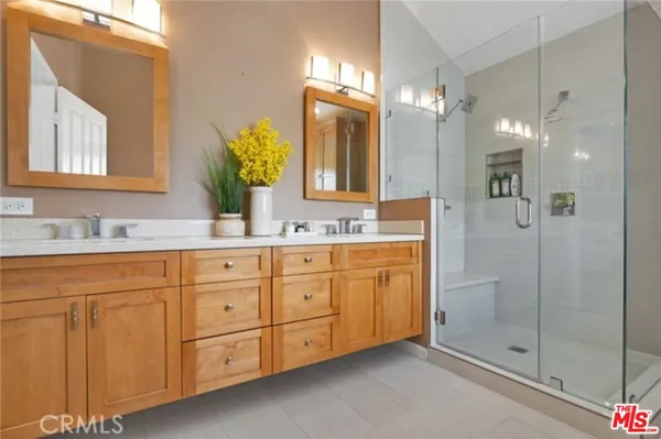 a bathroom with double sink and a mirror
