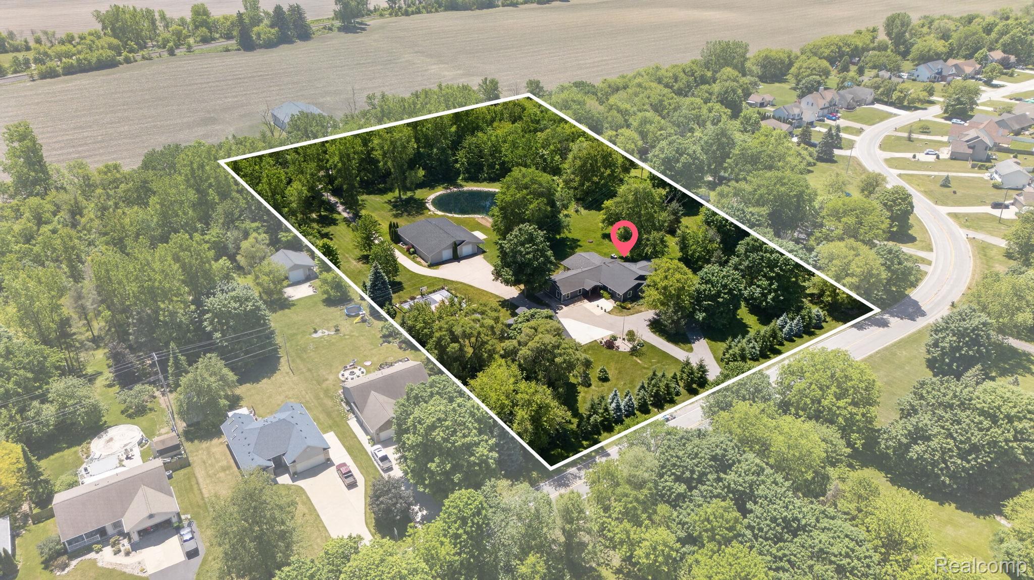 9353 Hill Road Swartz Creek, MI 48473 - Photo 94 of 98 Aerial overview showcasing a property with extensive landscaping, a private pond, and multiple structures