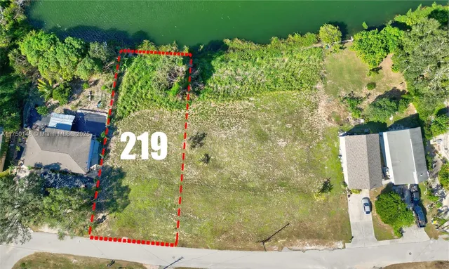 a sign that is sitting in front of flowers