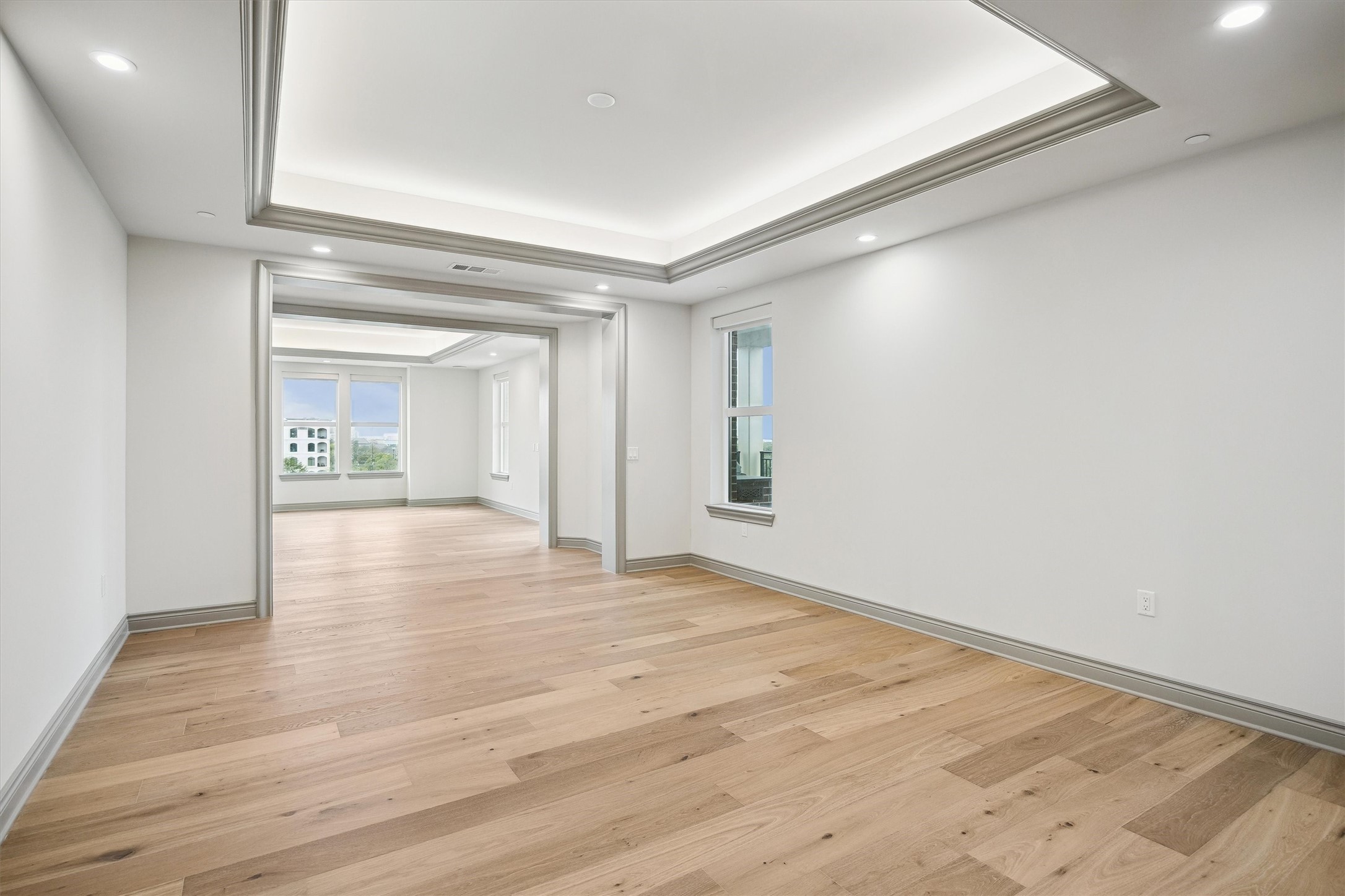 1717 Bissonnet Street, Unit 507 Houston, TX 77005 - Photo 11 of 35 a view of an empty room with wooden floor and a window